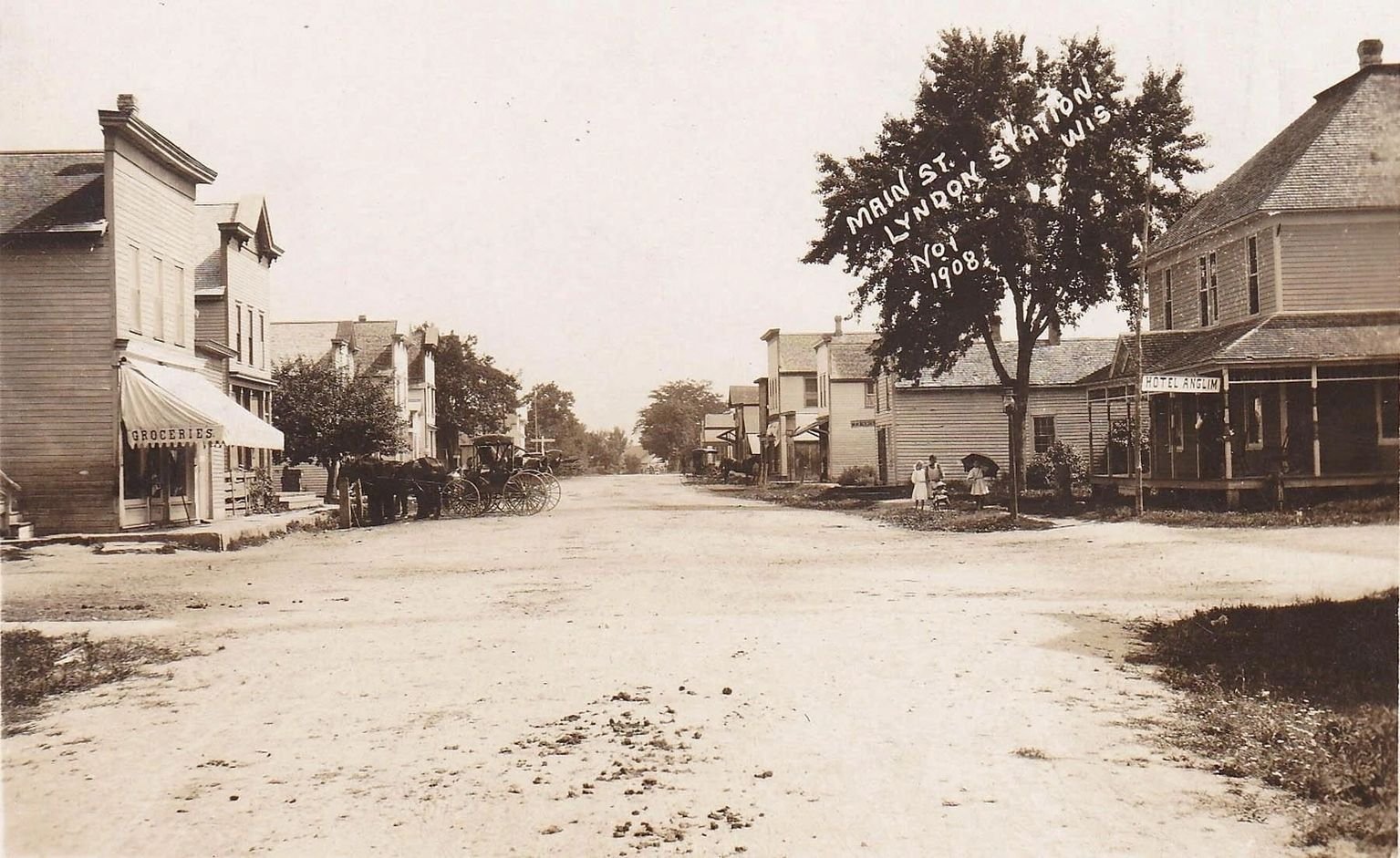 Main Street, Lyndon Station, Wisconsin in November 1908 — dirt road lined with wooden storefronts